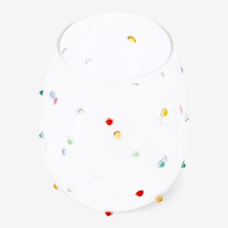 Drinking glass with multi coloured dots