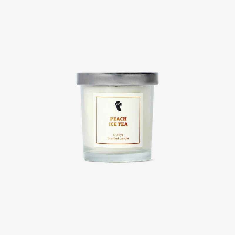 Scented candle with peach fragrance